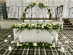 signing table with foliage floral arch and LED backdrop