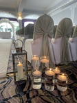 Sage Green drapes cylinders and lanterns for aisle
