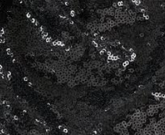 Black Sequin Linen Black sequined fabric with a shimmering, textured surface.